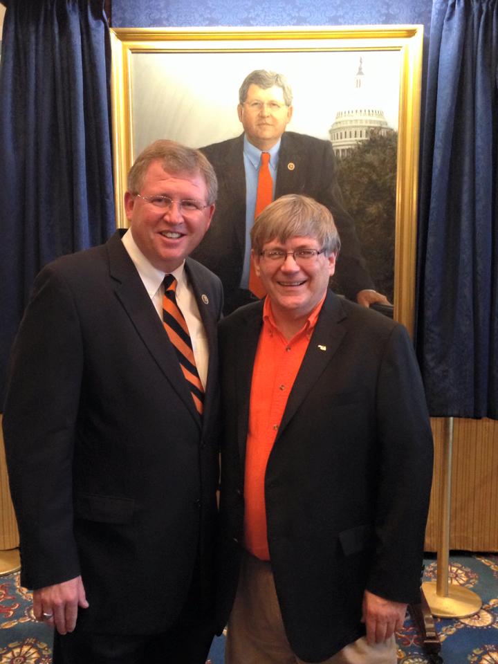 Congressman Lucas poses with friend Rodd Moesel in front of his portrait